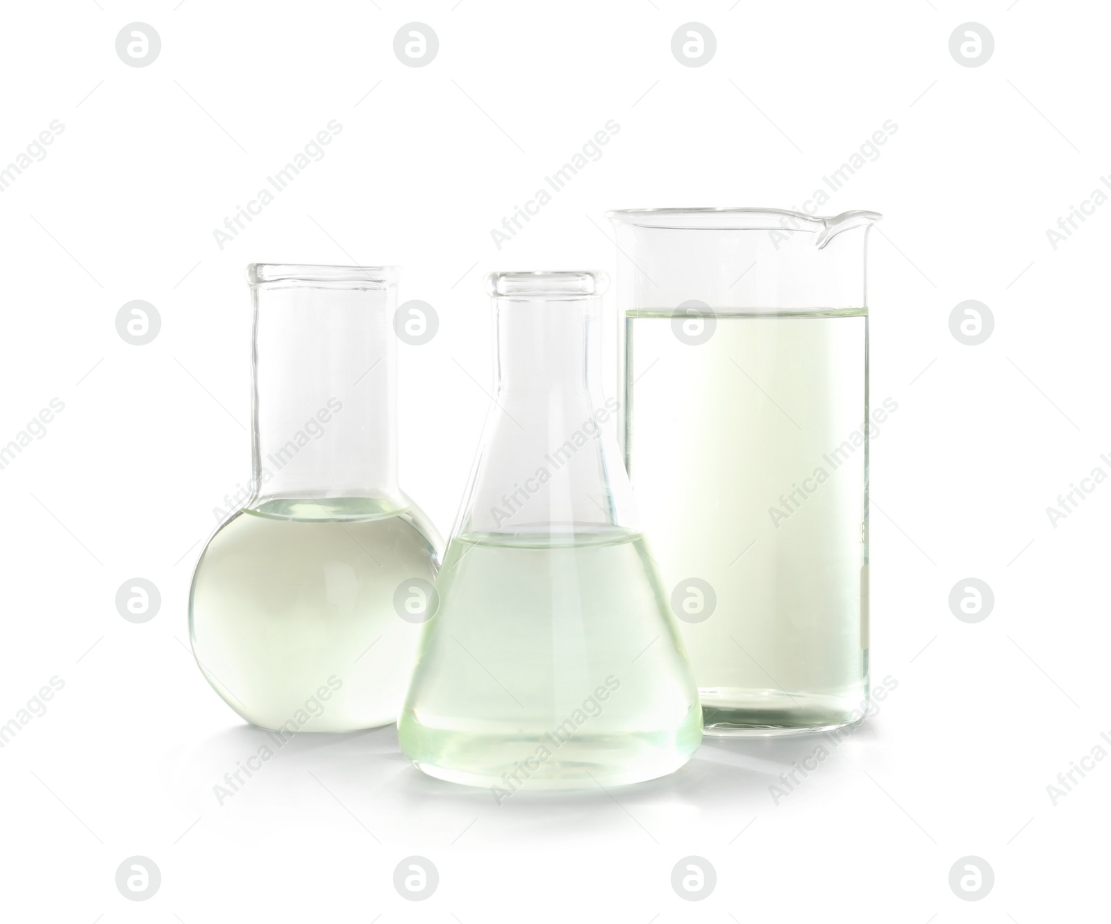 Photo of Laboratory glassware with liquid on white background. Chemical analysis