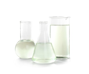 Photo of Laboratory glassware with liquid on white background. Chemical analysis