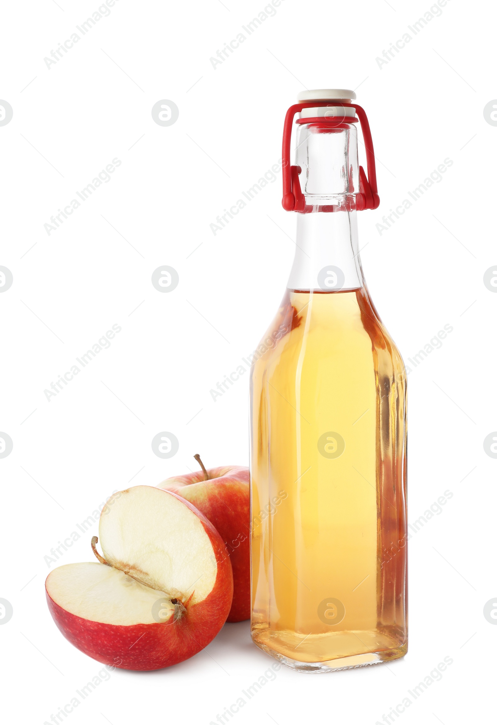 Photo of Glass bottle of vinegar and fresh apples on white background