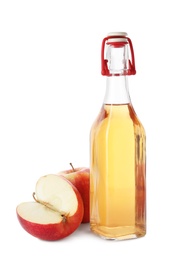 Photo of Glass bottle of vinegar and fresh apples on white background