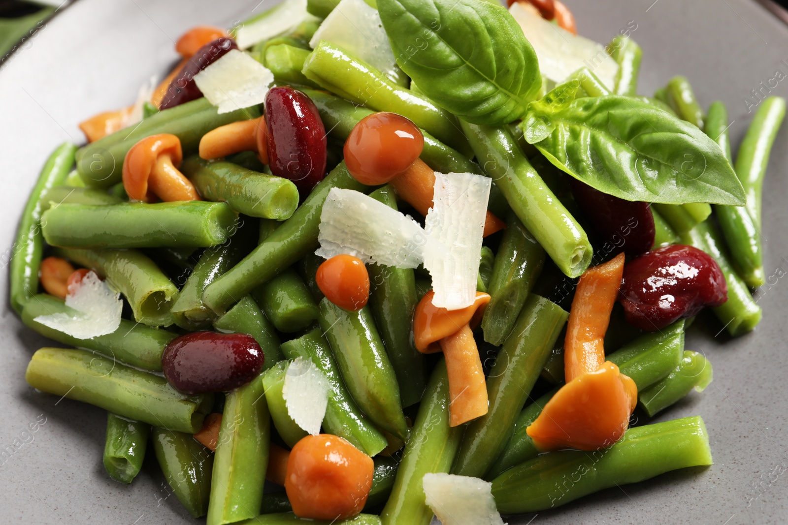 Photo of Delicious salad with green beans, mushrooms and cheese on plate, closeup