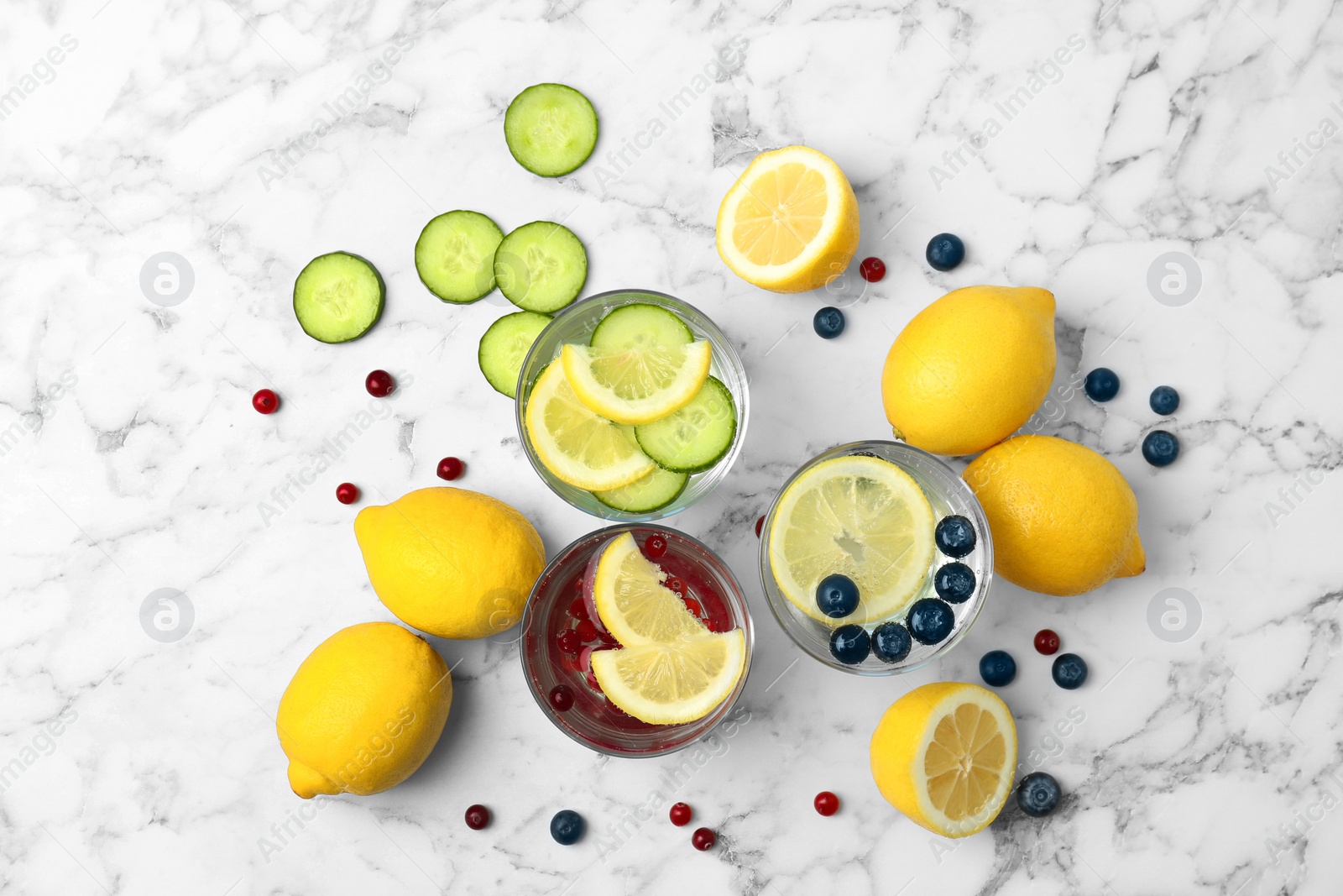 Photo of Flat lay composition with delicious natural lemonade on marble background
