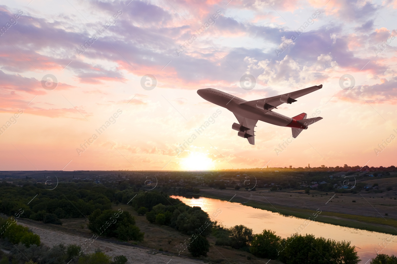 Image of Modern airplane flying in sky during sunset