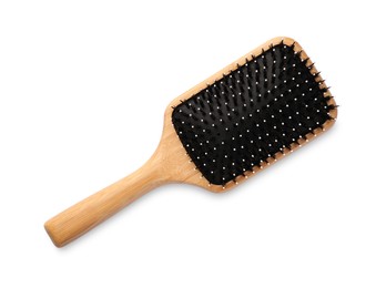 Photo of New wooden hair brush isolated on white, top view