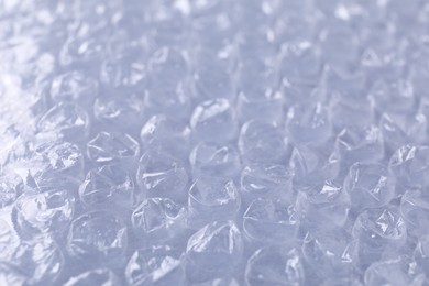 Photo of Transparent bubble wrap on gray background, closeup