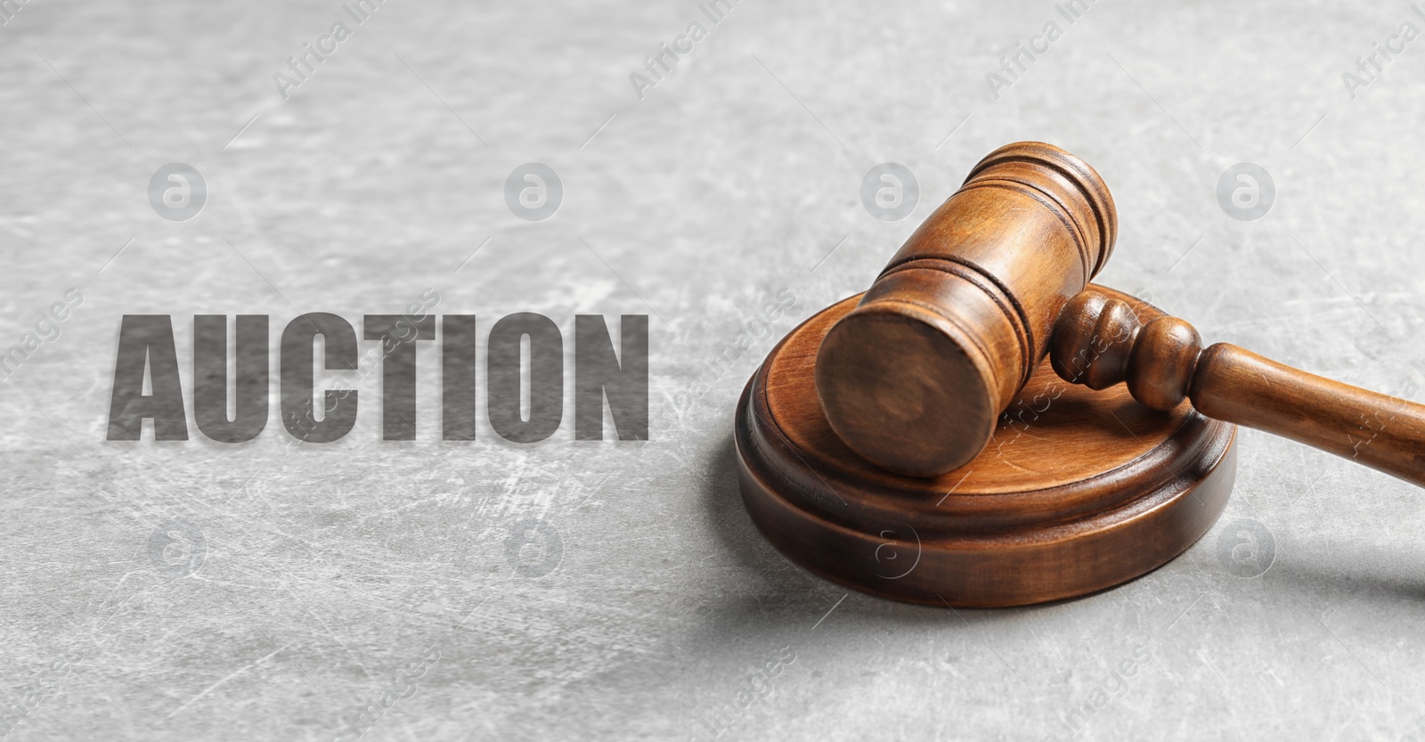 Image of Auction. Wooden gavel on grey textured table, banner design