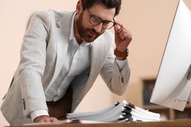 Photo of Happy businessman working with documents in modern office