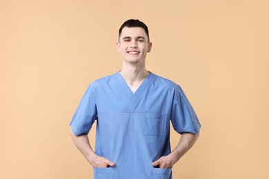 Photo of Portrait of smiling medical assistant on beige background