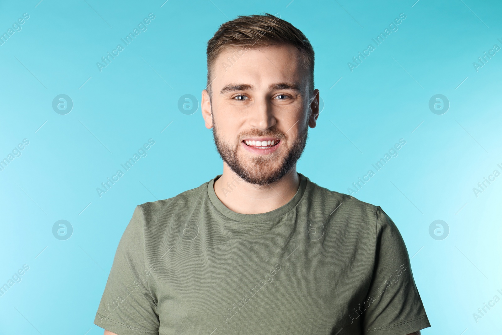 Photo of Young man with healthy teeth on color background