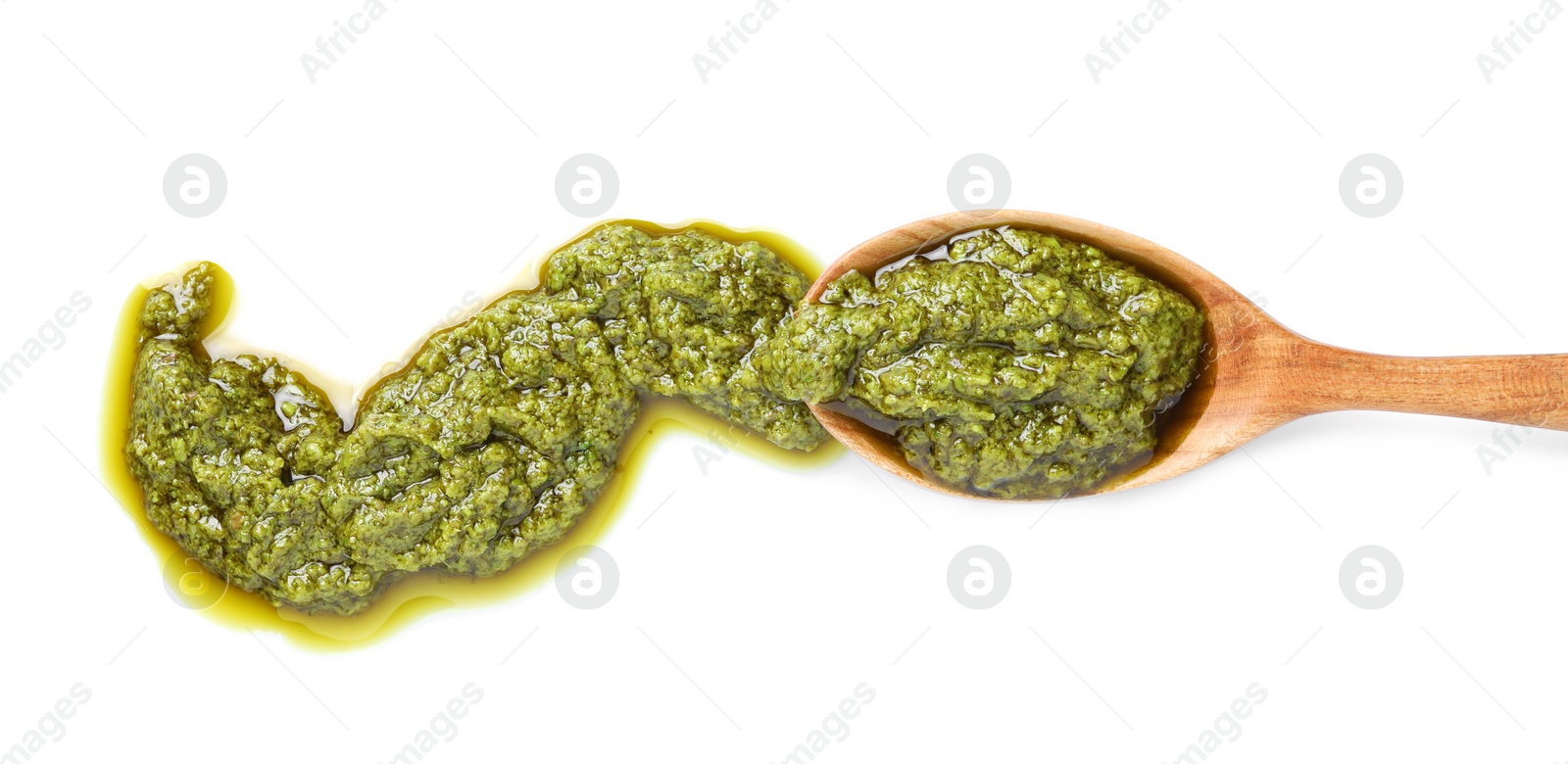 Photo of Sample of tasty pesto sauce and spoon isolated on white, top view