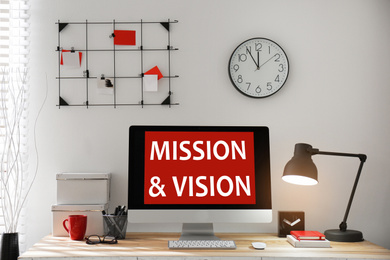 Image of Modern computer with phrase MISSION AND VISION indoors 
