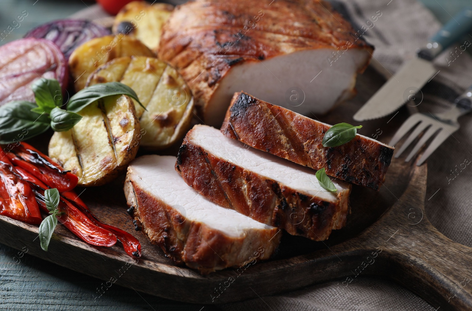 Photo of Delicious grilled meat and vegetables served on wooden table, closeup