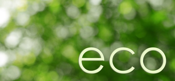 Image of Word ECO on blurred green background. Bokeh effect