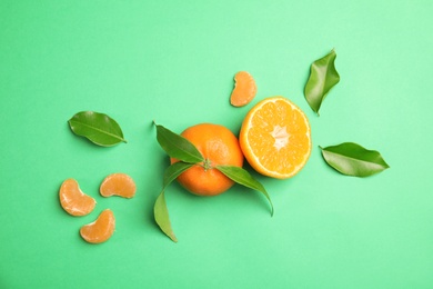 Photo of Flat lay composition with ripe tangerines on color background