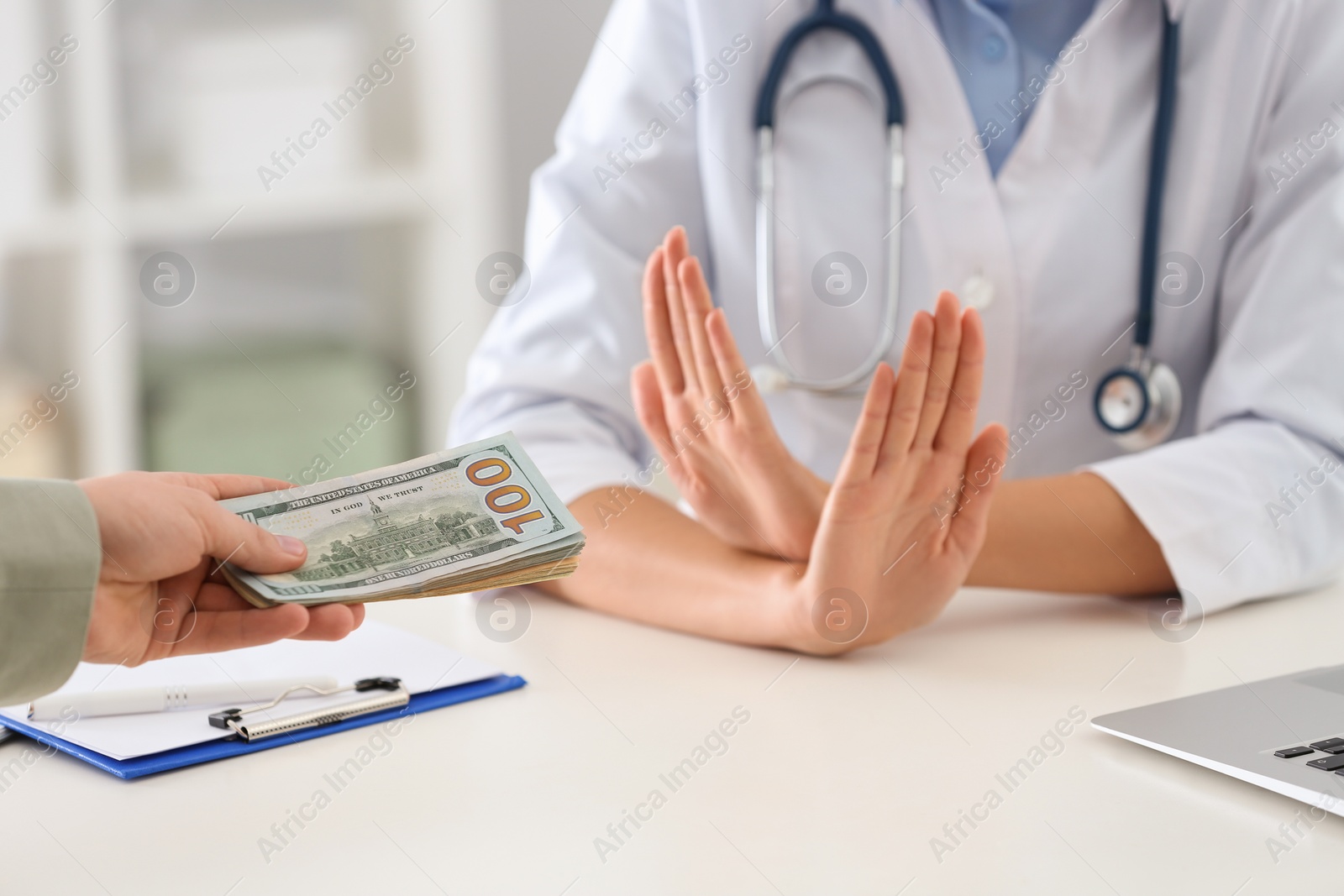 Photo of Doctor rejecting bribe in clinic, closeup. Corrupted medicine