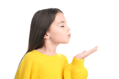 Cute little girl blowing air kiss on white background