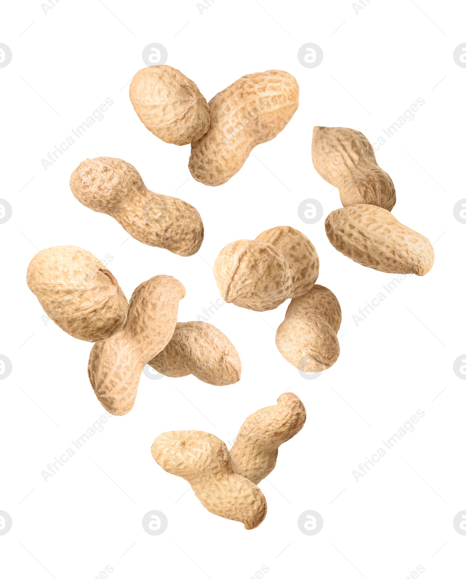 Image of Unpeeled peanuts in air on white background