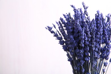 Photo of Bouquet of beautiful preserved lavender flowers on white background, closeup. Space for text