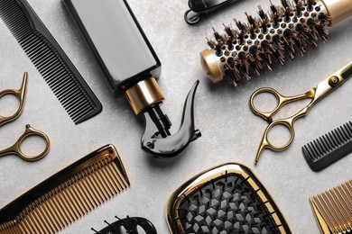 Photo of Hairdressing tools on light background, flat lay