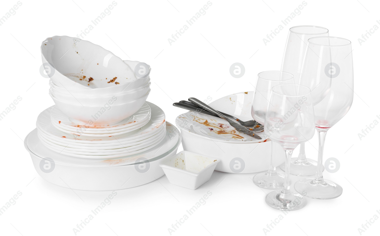 Photo of Many dirty dishes and glasses isolated on white