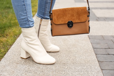 Woman in stylish leather shoes with bag outdoors, closeup