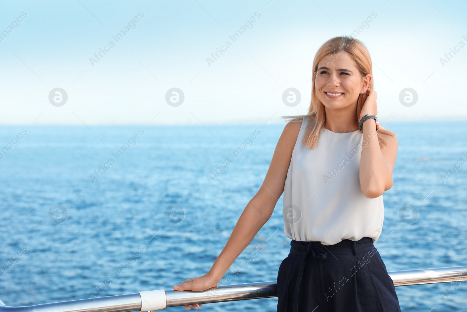 Photo of Portrait of beautiful blonde woman near sea, space for text