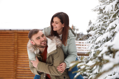 Lovely couple spending time together on snowy day. Winter vacation