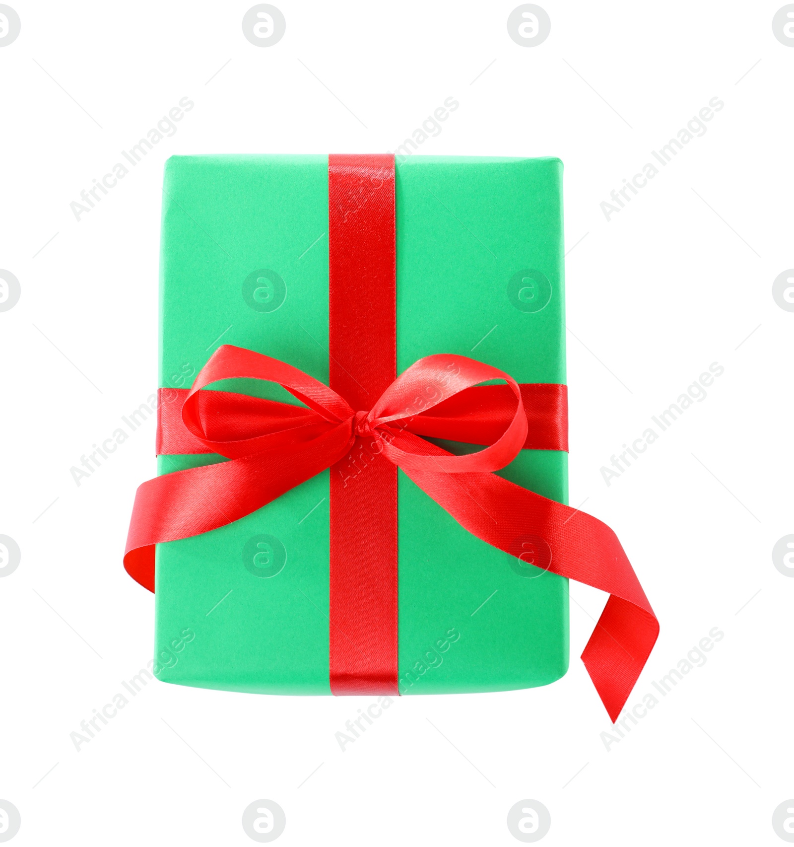 Photo of Christmas gift box decorated with ribbon bow on white background, top view