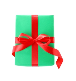 Photo of Christmas gift box decorated with ribbon bow on white background, top view