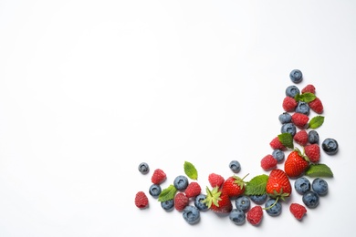 Mix of fresh berries on white background, flat lay