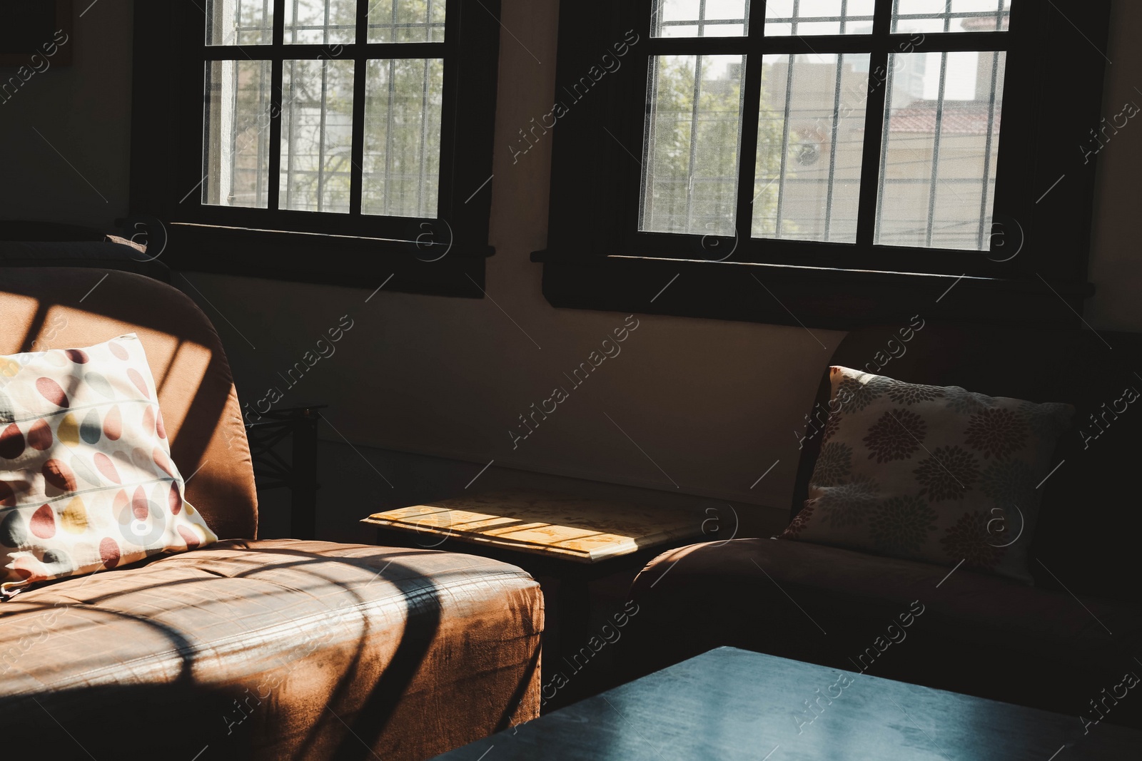 Photo of Cozy cafe interior with sofas and table