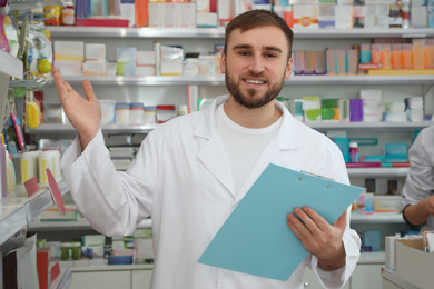 Image of Professional pharmacist with clipboard in modern drugstore