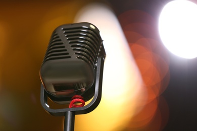 Photo of Retro microphone against festive lights, space for text. Musical equipment