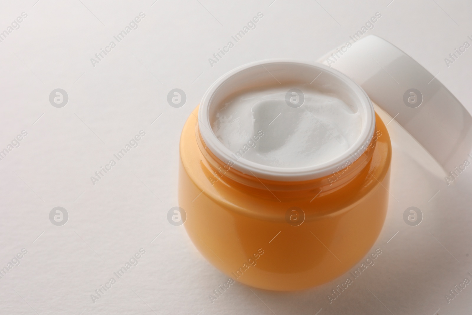 Photo of Jar of face cream on white background, closeup. Space for text