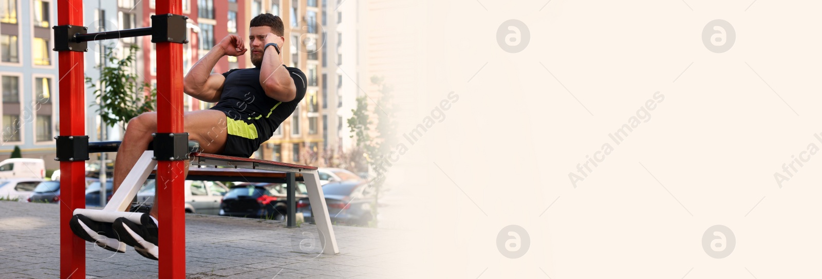 Image of Handsome man doing abs exercise on bench at outdoor gym, space for text. Banner design