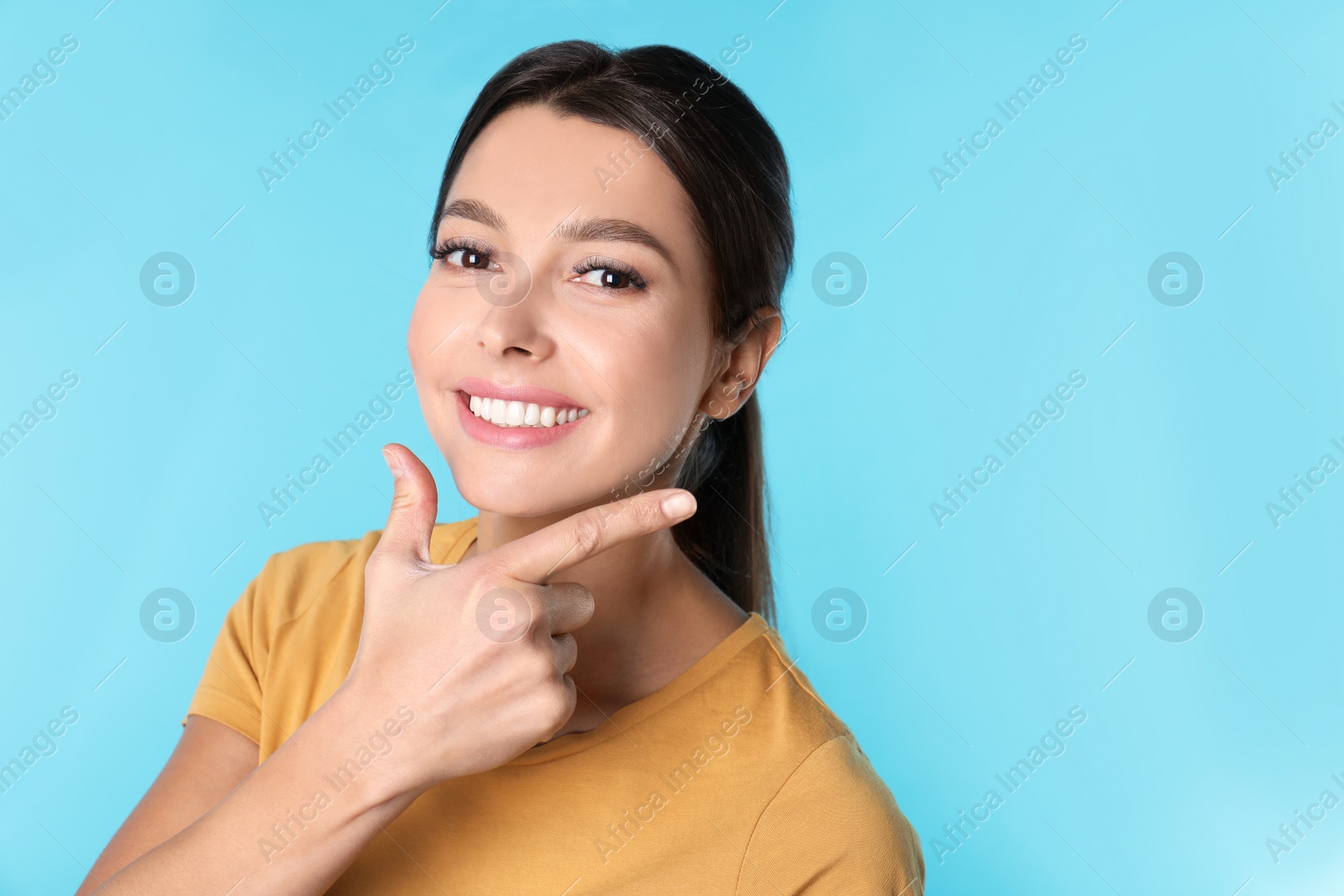 Photo of Young woman with healthy teeth on color background. Space for text