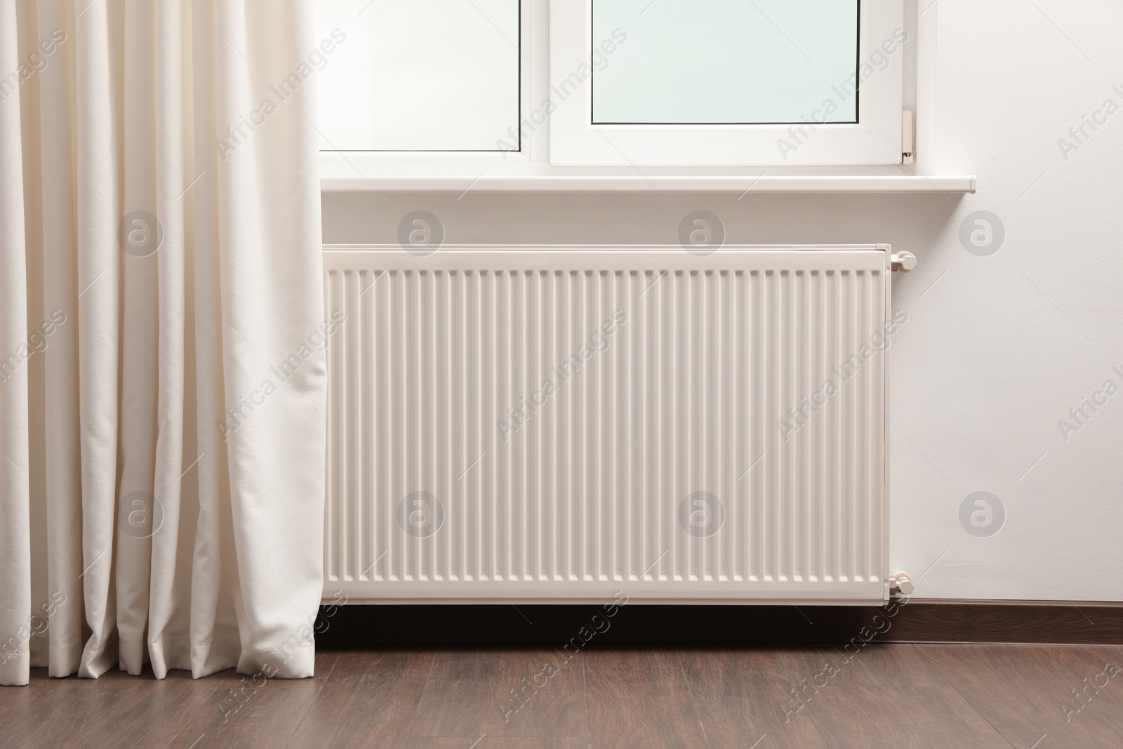 Photo of Modern radiator at home. Central heating system