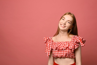 Photo of Portrait of happy young woman on pink background, space for text