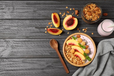 Healthy homemade granola with yogurt on grey wooden table, flat lay. Space for text