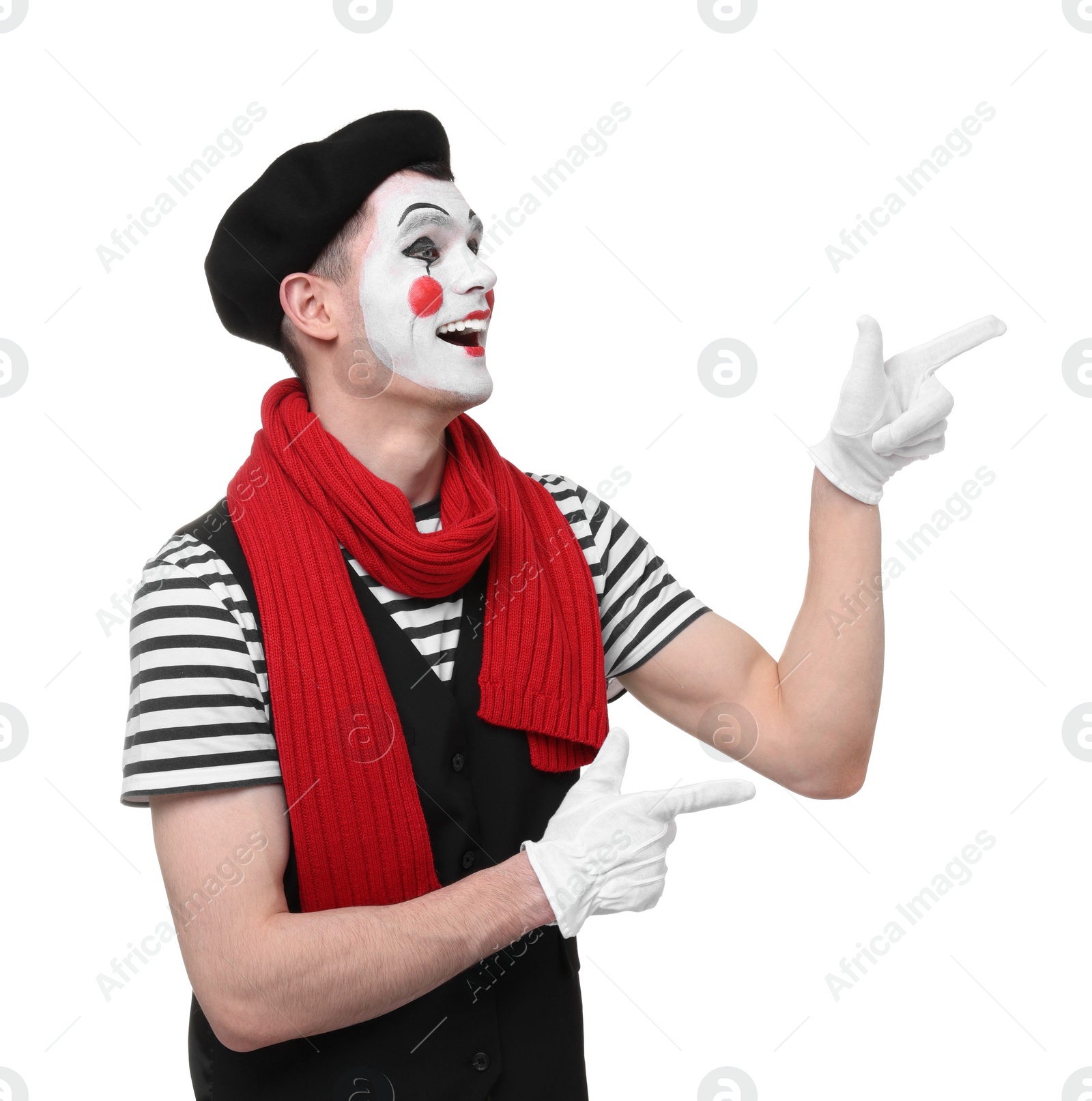 Photo of Funny mime artist pointing at something on white background