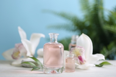 Photo of Beautiful spa composition with essential oil on white table, closeup