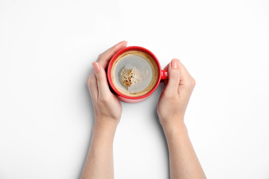 Woman with cup of coffee on white background, top view