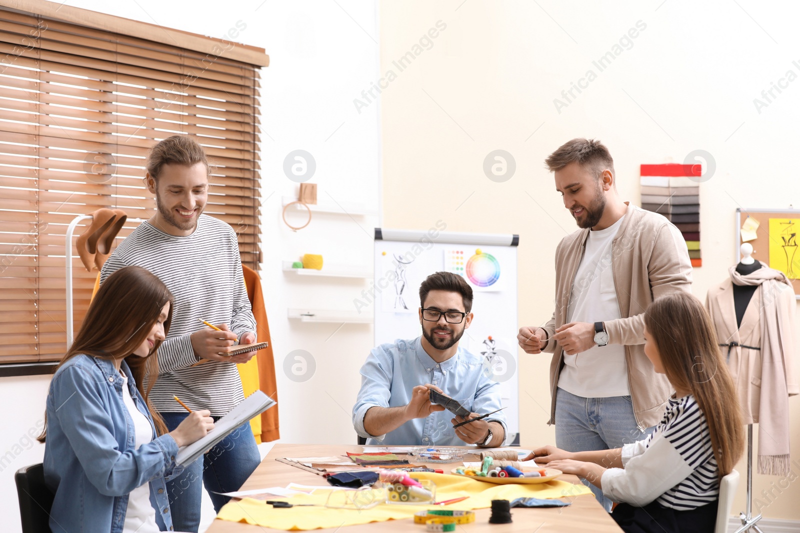 Photo of Fashion designers creating new clothes in studio