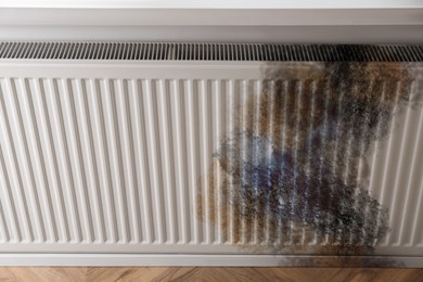 Image of Modern panel radiator affected by rust indoors