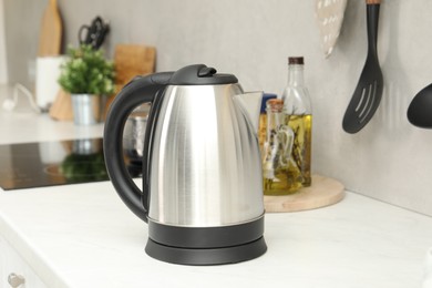 Modern electric kettle on counter in kitchen