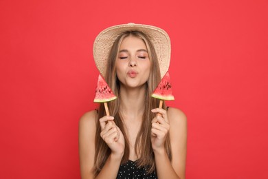 Photo of Beautiful girl with pieces of watermelon on red background