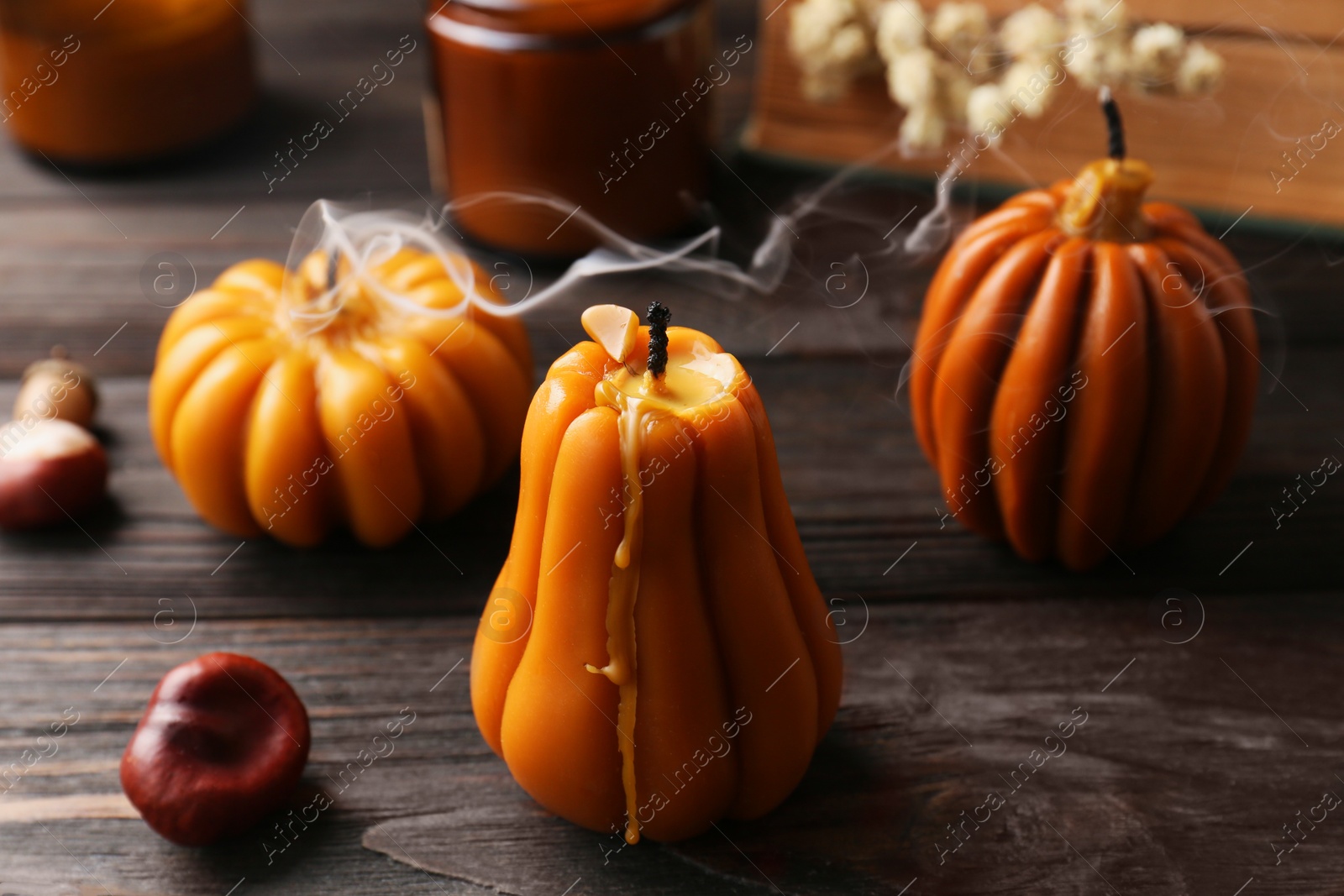 Photo of Blown out candles on wooden table. Autumn atmosphere