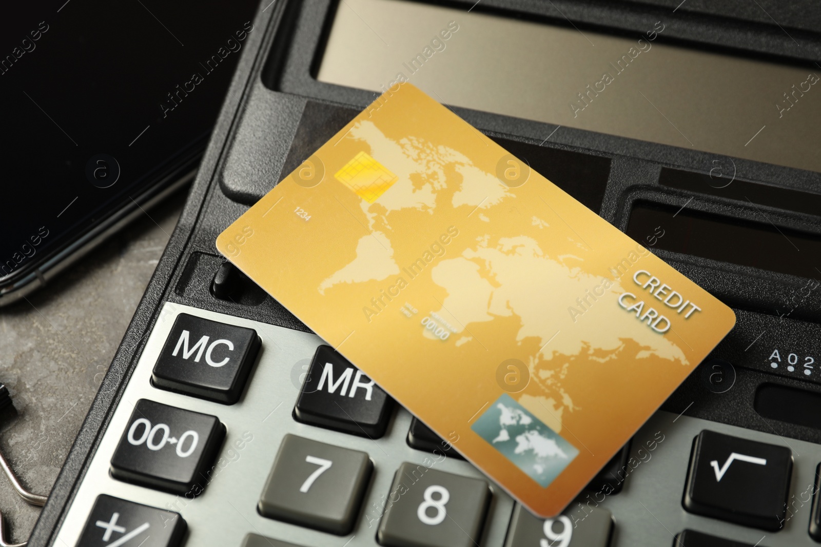 Photo of Credit card and calculator on table, closeup