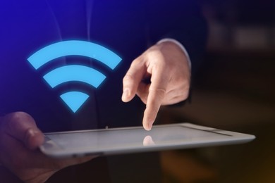 Image of Man using tablet connected to WiFi indoors, closeup