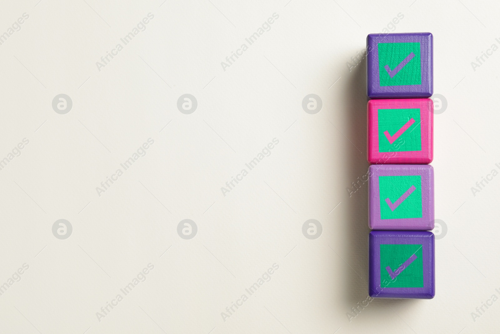 Image of Cubes with check marks on beige background, top view. Space for text